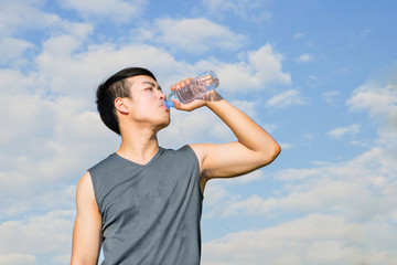 Thirsty athlete drinking water after workout