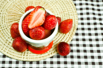 Fresh strawberries in cup,fabric checker textile