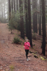 Obraz premium Woman running in forest woods training