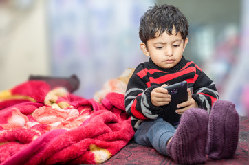 boy child playing with mobile phone