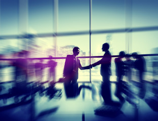 Obraz premium Two Businessmen Handshaking Together Colleagues Concept