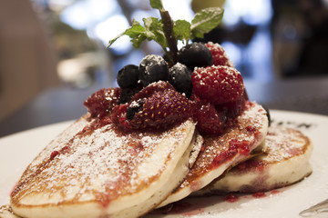 Breakfast of buttermilk pancakes with fresh berries