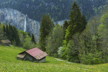 Hut and waterfall in Lauterbrunnen, Switzerland.