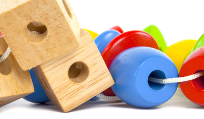 multicolor wooden bricks stacked on a white background