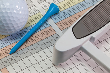 Golf  equipments  lying  on a golf score card
