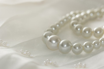 Pearl necklace on lace background,selected focus.