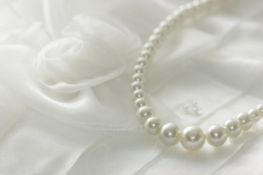 Pearl necklace on lace background,selected focus.