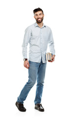 Fototapeta premium Young bearded smiling man with books in hand on white