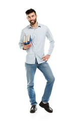 Young bearded smiling man with books in hand on white