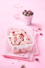 Rose Meringue Cookies in a plastic container