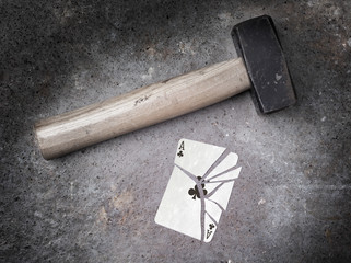 Hammer with a broken card, ace of clubs