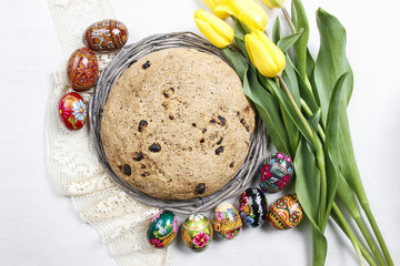 Festive easter bread, beautiful yellow tulips and easter eggs
