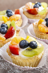 Cupcakes with cream and fresh fruits