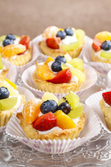Cupcakes with cream and fresh fruits
