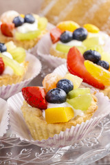 Cupcakes with cram and fresh fruits