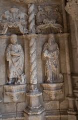 The wall of an old building with sculptures