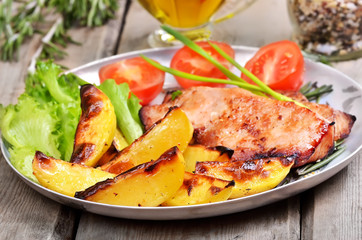 Baked potatoes and grilled pork steak