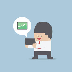 Businessman holding a tablet with growing graph