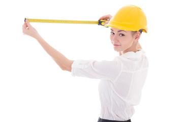 business woman architect in yellow builder helmet measuring some