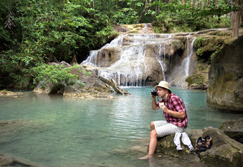 tourist resting near a waterfall