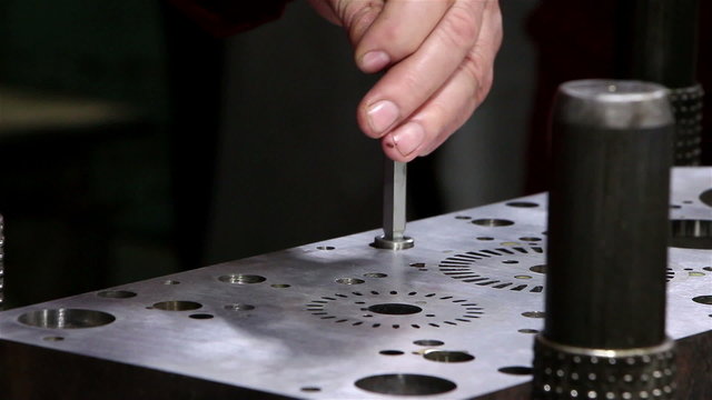 Heavy industry - Man tightening a bolt or screw using a socket