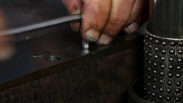 Heavy industry - Man tightening a bolt or screw using a socket