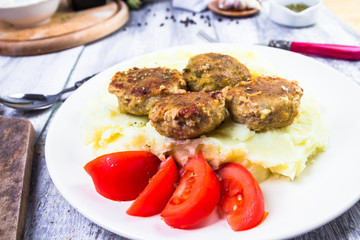 Fried pork chops boiled potatoes tomatoes