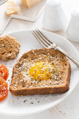fried egg in a toast and grilled tomatoes, vertical