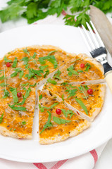 sliced ​​chicken pizza with tomato sauce, cheese and herbs