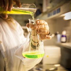 Scientist works with a green aqueous solution