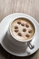 White coffee cup on wooden background.