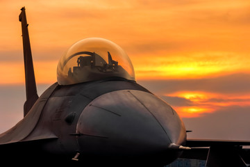 Fototapeta na wymiar f16 falcon fighter jet on sunset background