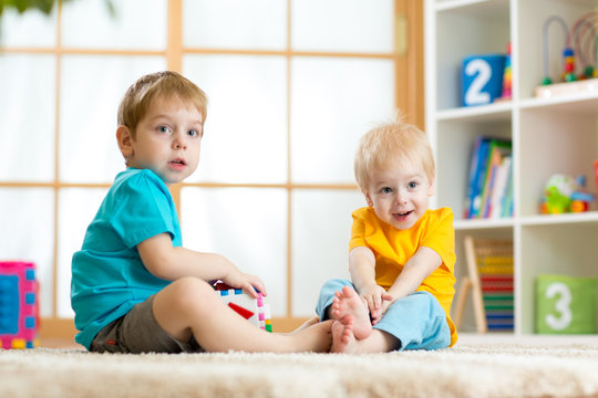 two little boys play together with educational toys