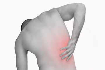 Naklejka premium Rear view of shirtless man with back pain