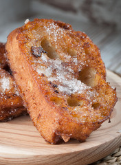 One french toast on a wooden plate