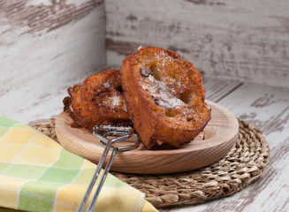 French toasts on a wooden plate.