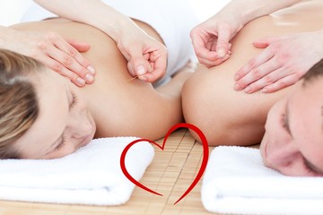 Composite image of relaxed couple in an acupuncture therapy