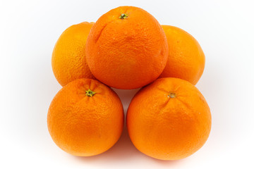 Oranges stacked as pyramid with white background