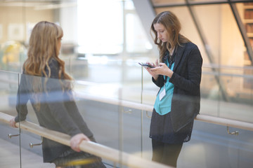 Young women standing in the office corridor