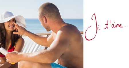 Handsome man applying sun cream on his girlfriends nose