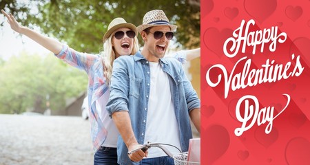 Fototapeta premium Composite image of hip young couple going for a bike ride