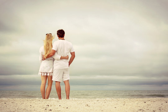 A Happy Couple Isstanding On Beach At Morning, Vintage Color