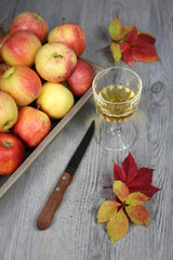 Apple juice, apples and autumn leaves