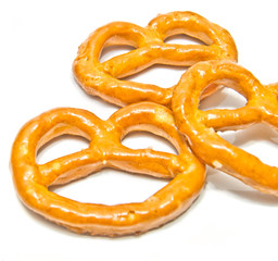 three salted pretzels closeup on white