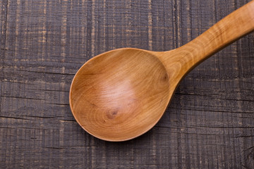 Rustic old wooden spoon. On the table.