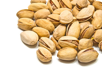 heap of tasty pistachios on white
