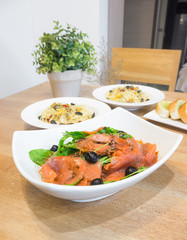 Smoked salmon rocket salad on the white  bowl