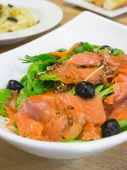 Smoked salmon rocket salad on the white  bowl