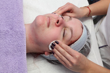 Skin treatment beautician clean face of young female real people