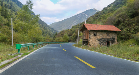 road in the mountain with discarded house